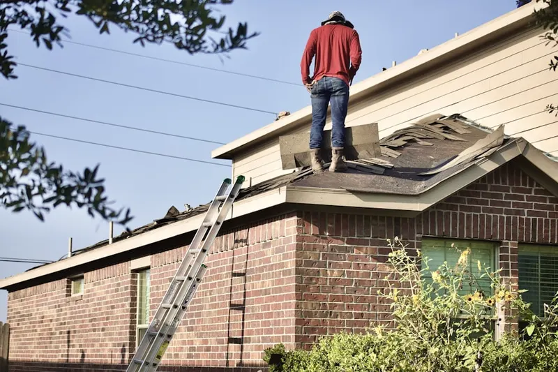 Professional roofer working on a residential roof in Hiawatha